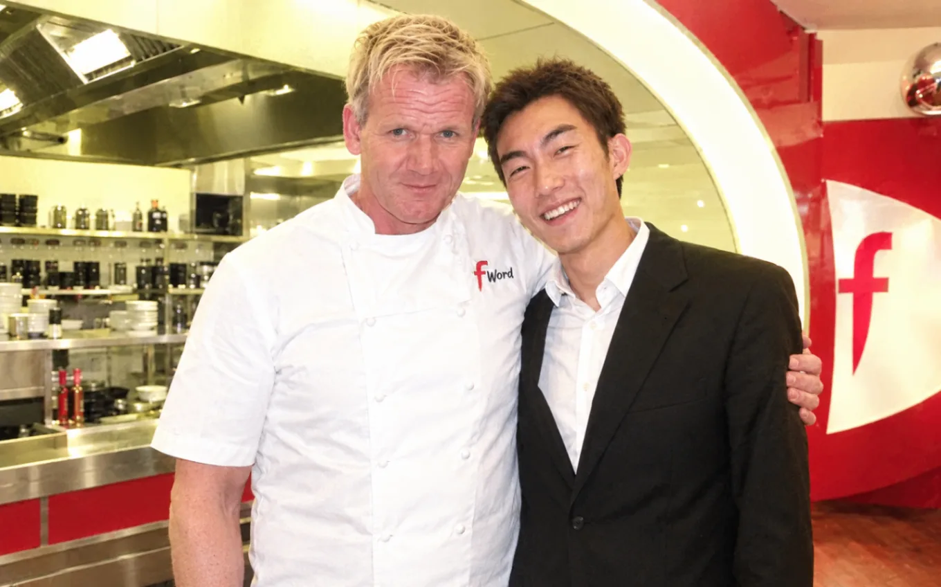 Yin Fei standing beside Gordon Ramsay in a professional restaurant kitchen during The F Word
